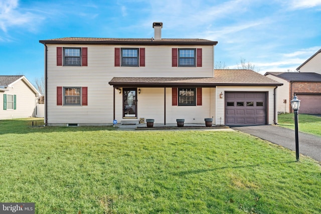 front facade featuring a garage and a front yard