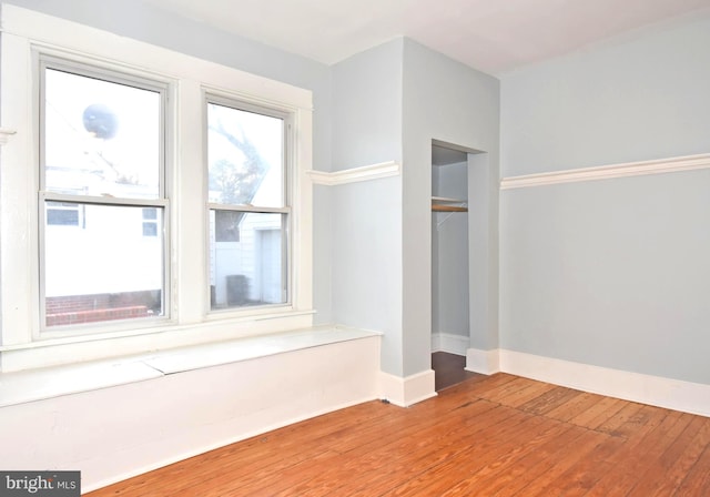 unfurnished room featuring hardwood / wood-style flooring