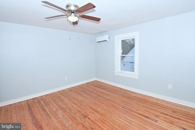 empty room with ceiling fan, a wall mounted AC, and light wood-type flooring