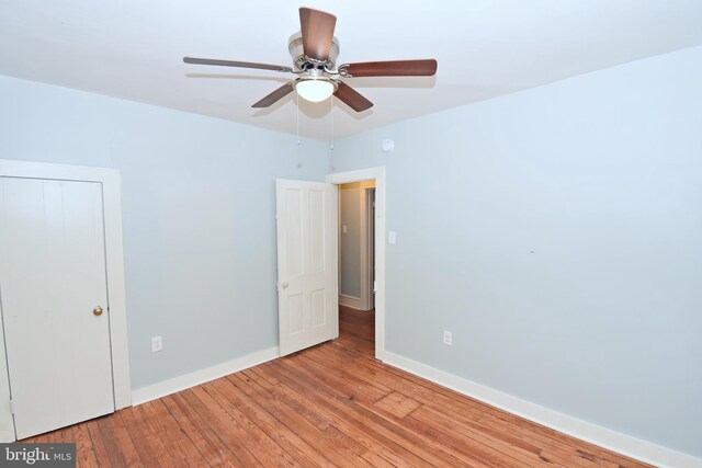 interior space featuring ceiling fan, a closet, and light wood-type flooring