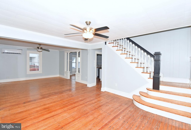 unfurnished living room with light hardwood / wood-style flooring, a wall unit AC, and ceiling fan