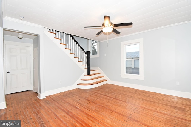 interior space with hardwood / wood-style flooring, ornamental molding, and ceiling fan