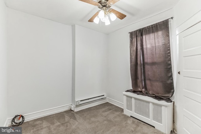 empty room featuring a baseboard heating unit, ceiling fan, and carpet