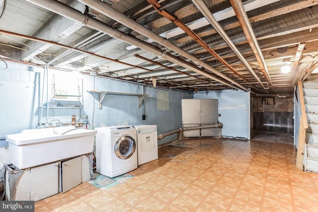 laundry room with separate washer and dryer and sink