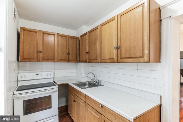 kitchen with tasteful backsplash, sink, and white range with electric cooktop