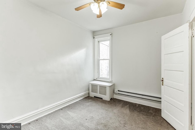 spare room featuring carpet, a baseboard heating unit, radiator, and ceiling fan