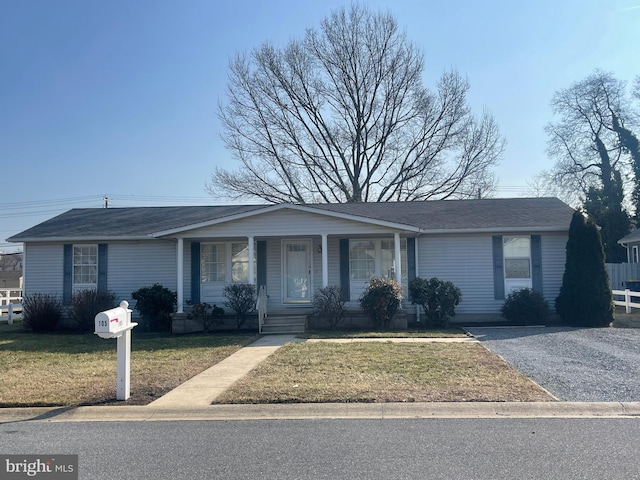 ranch-style home with a porch and a front yard