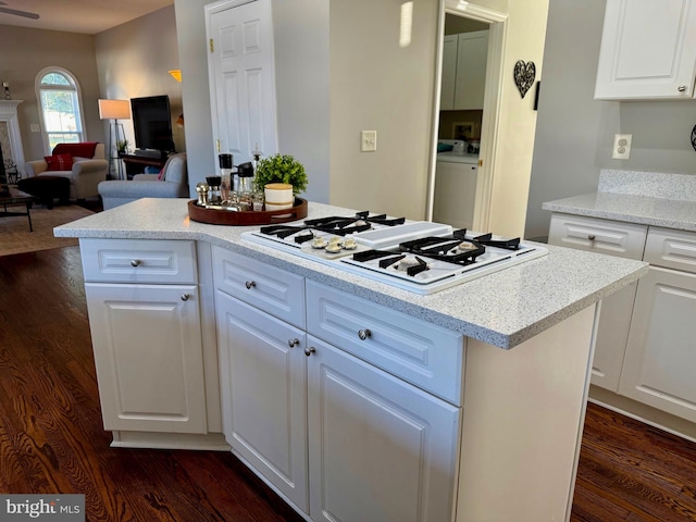 kitchen with white cabinetry, white gas cooktop, and a kitchen island