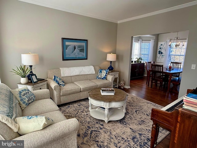 living room featuring ornamental molding, dark hardwood / wood-style floors, and a notable chandelier