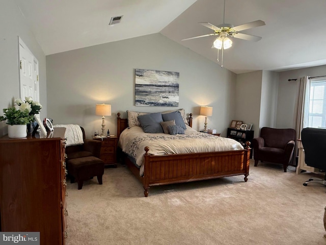 bedroom featuring vaulted ceiling, light colored carpet, and ceiling fan