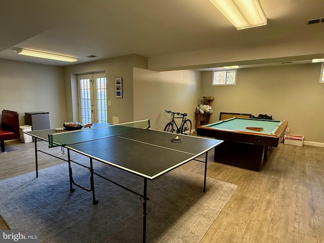 rec room featuring french doors, light hardwood / wood-style floors, and a wealth of natural light