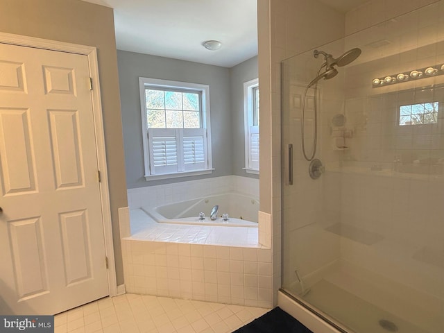 bathroom featuring tile patterned floors and separate shower and tub