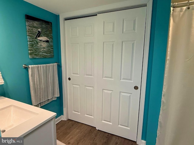 bathroom featuring vanity, hardwood / wood-style floors, and curtained shower