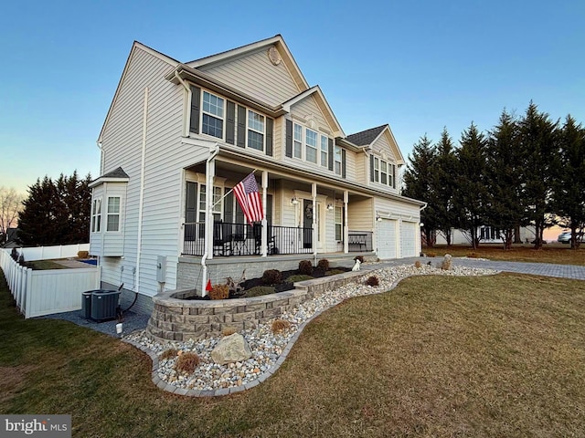 view of front facade featuring a front yard, covered porch, and cooling unit