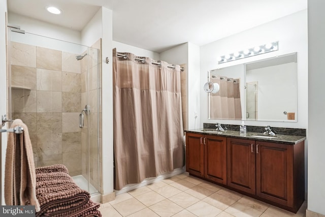 bathroom featuring vanity, tile patterned flooring, and a shower with shower door