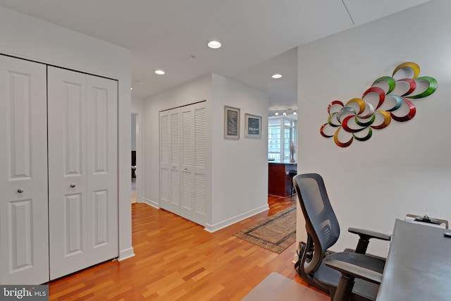 home office with light hardwood / wood-style floors