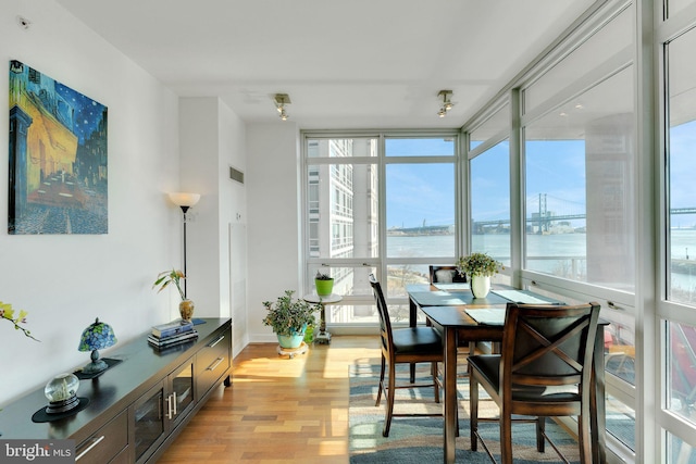 sunroom / solarium with a water view