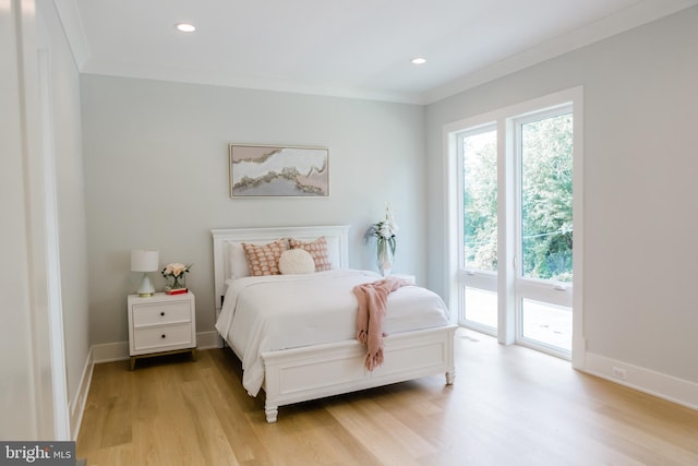 bedroom with baseboards, light wood-style floors, ornamental molding, and access to outside