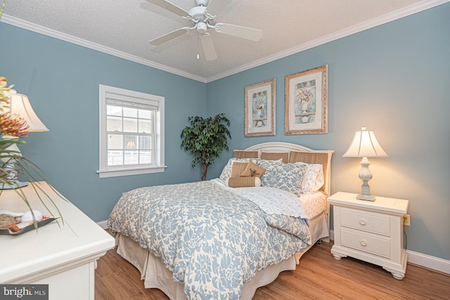 bedroom with crown molding, ceiling fan, a textured ceiling, and light hardwood / wood-style flooring