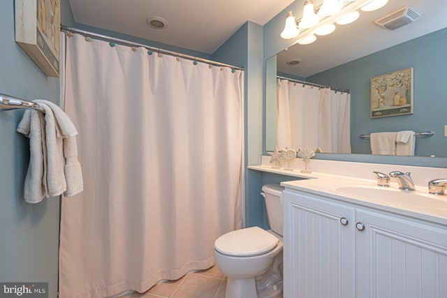 bathroom featuring vanity, tile patterned floors, and toilet