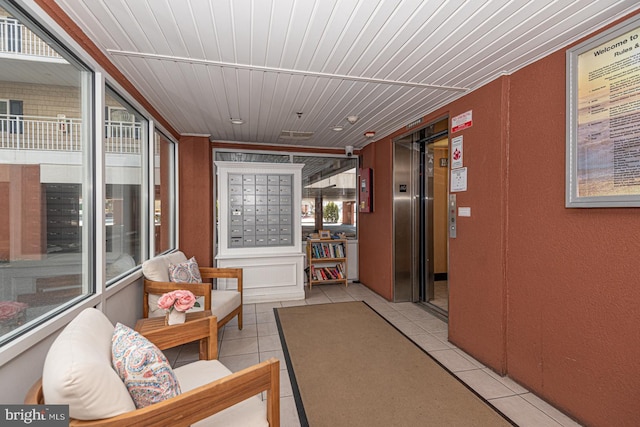 interior space featuring elevator, wooden ceiling, mail boxes, and light tile patterned floors