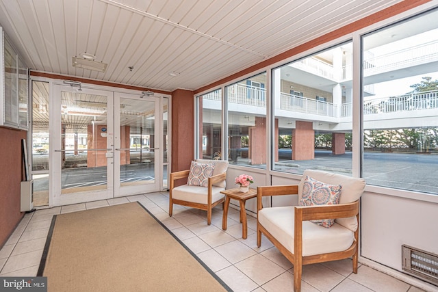 sunroom / solarium with wood ceiling and a healthy amount of sunlight