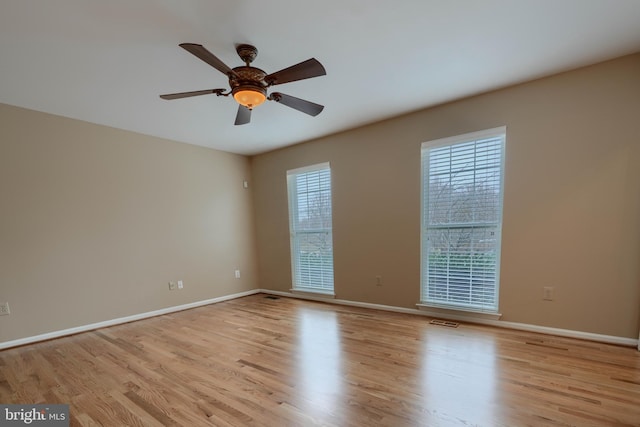 unfurnished room with ceiling fan and light wood-type flooring