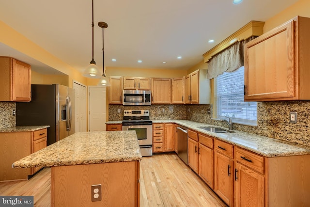 kitchen with sink, decorative light fixtures, a kitchen island, stainless steel appliances, and decorative backsplash