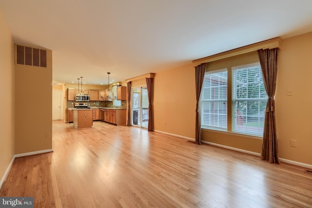 unfurnished living room with light wood-type flooring