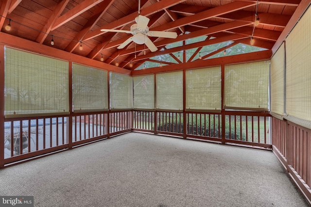 unfurnished sunroom with ceiling fan and lofted ceiling with beams