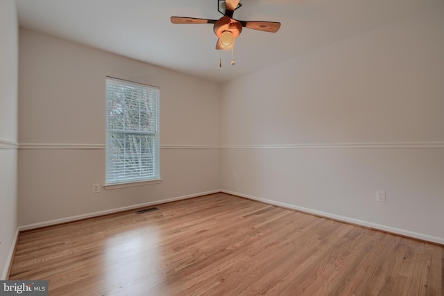 empty room with ceiling fan and light wood-type flooring