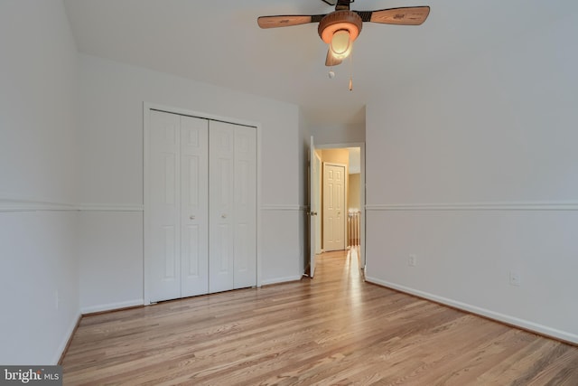 unfurnished bedroom featuring light hardwood / wood-style flooring, a closet, and ceiling fan