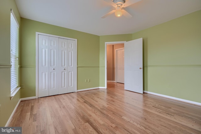 unfurnished bedroom featuring ceiling fan, light hardwood / wood-style floors, and a closet