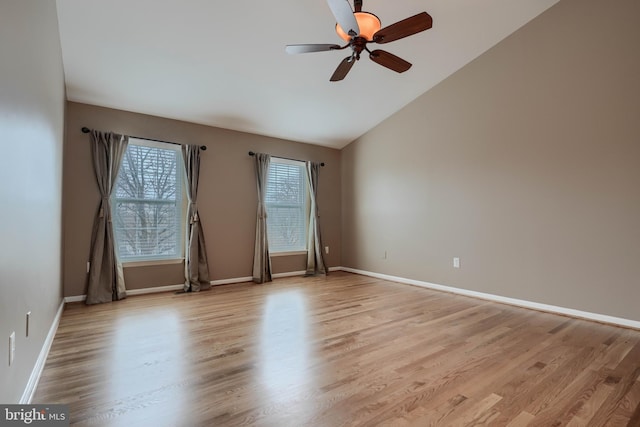 spare room featuring light hardwood / wood-style flooring, ceiling fan, and vaulted ceiling