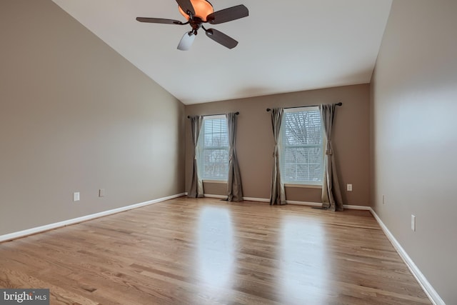 empty room with vaulted ceiling, ceiling fan, and light hardwood / wood-style floors