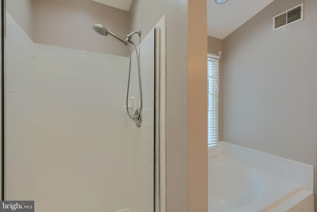 bathroom featuring separate shower and tub