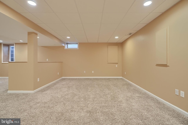 basement with carpet and a drop ceiling