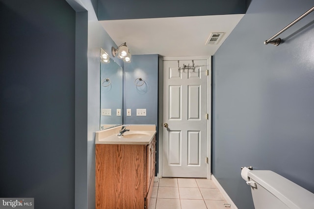 bathroom with vanity, toilet, and tile patterned flooring