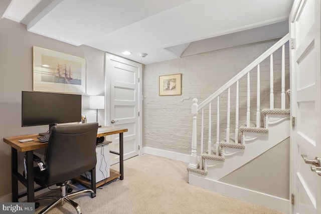 office space with carpet floors, recessed lighting, baseboards, and brick wall