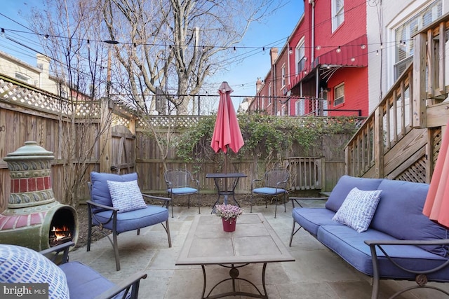 view of patio with an outdoor hangout area and fence private yard