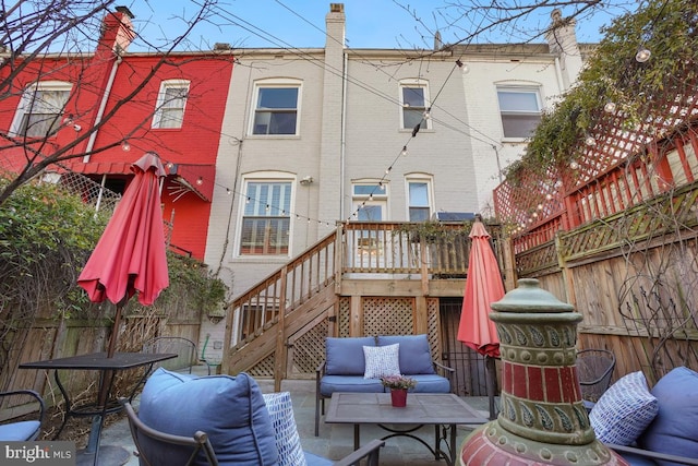 exterior space featuring stairs, a patio, brick siding, and fence