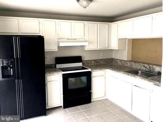 kitchen with range with electric cooktop, black refrigerator with ice dispenser, sink, and white cabinets