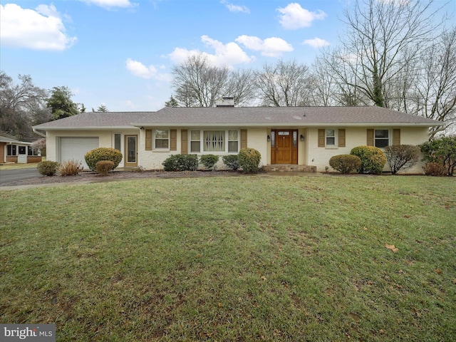 ranch-style home featuring a garage and a front yard