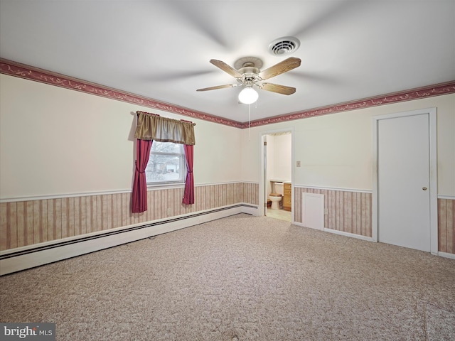 carpeted empty room featuring ceiling fan and baseboard heating