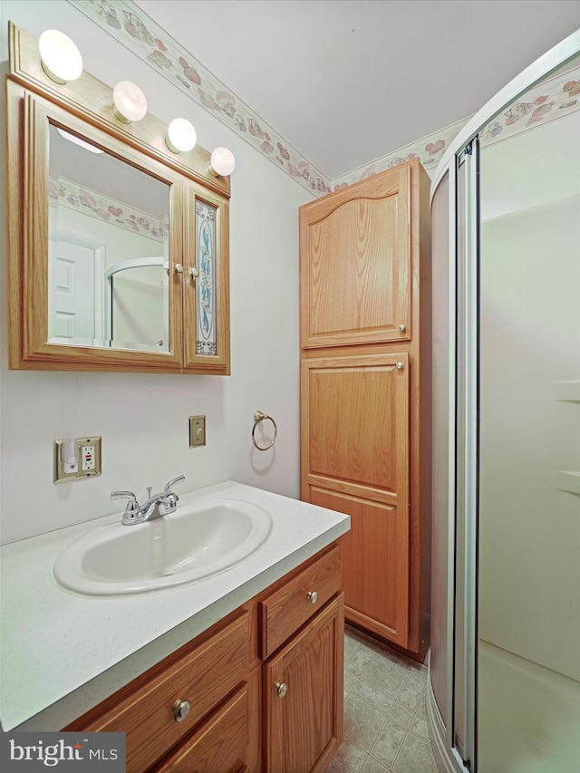 bathroom with vanity and an enclosed shower