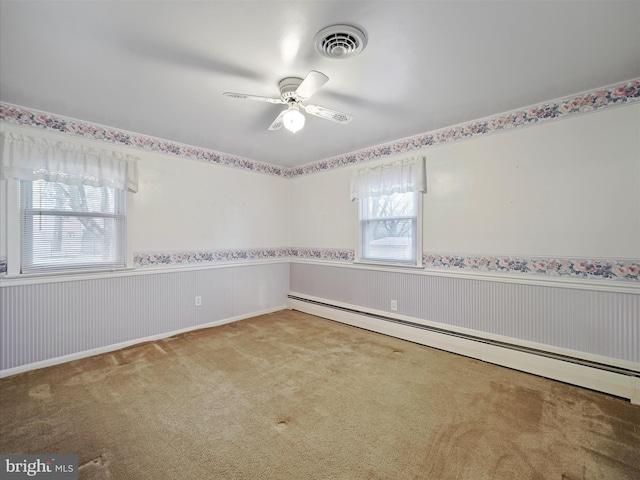 unfurnished room featuring carpet floors, ceiling fan, and baseboard heating