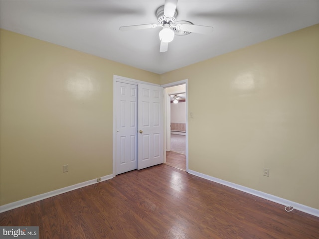 unfurnished bedroom with hardwood / wood-style floors, ceiling fan, and a closet