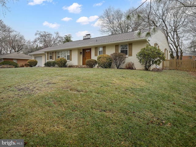 ranch-style house featuring a garage and a front yard