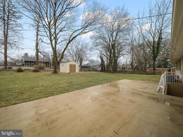 view of yard with a shed and a patio