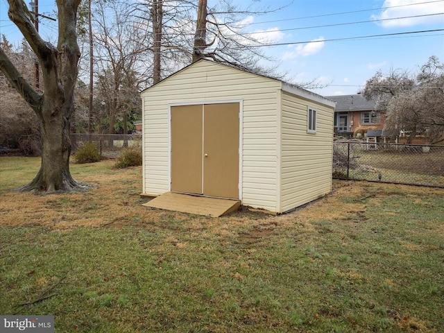 view of outbuilding with a yard